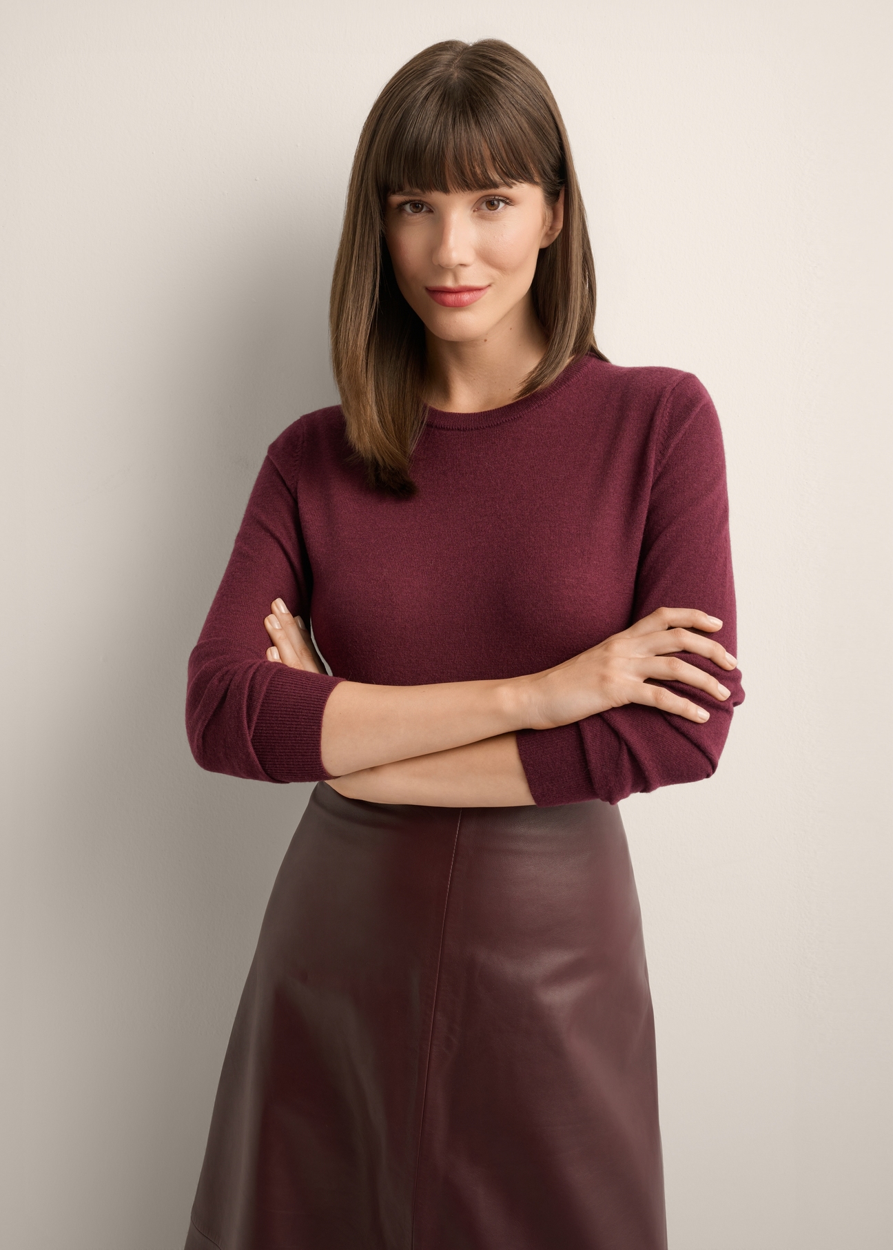 Wełniany sweter w kolorze bordowym SWEDT-0267-4D(Z26), widok produktu z przodu na modelce. Widoczna połowa sylwetki.
