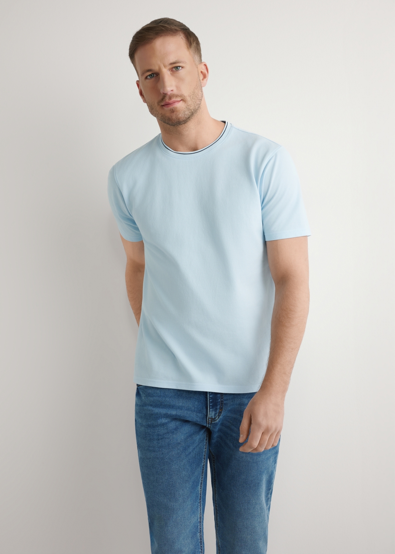 Jasnoniebieski T-shirt męski z bawełny TSHMT-0150-7A(W26), widok produktu z przodu na modelu. Widoczna połowa sylwetki.